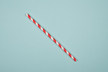 close-up of drinking straws for a party. Red spiral. Top view of colorful disposable eco friendly straws for summer cocktails. Paper cocktail colorful straw isolated on white blue, isolated.