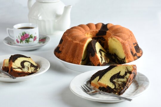homemade marble cake on a white plate with white backround