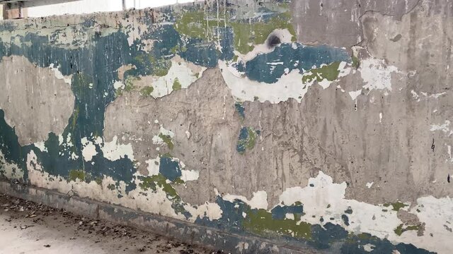 4K. Concrete dirty wall. Grunge grey pattern background. Cement wall of vintage tone with pieces of old green blue and white paint.