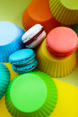 colored macaroons on a yellow background