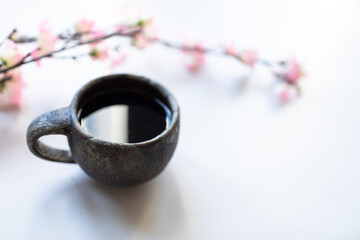 Singing bowl or Tibetan bowl on white table with cherry flower.