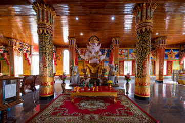 Chachoengsao / Thailand / October 25, 2020 : Wat Bang Prongtham Chotikaram, Beautiful new style, modern temple with plentyful golden decorations, Realistic statues of buddhist monks..