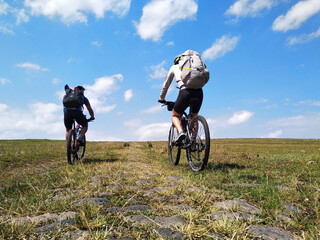 two person riding a mountain bike in the countryside