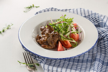 Balsamic Braised Beef slow cooked beef roast with fresh tomatoes on the table