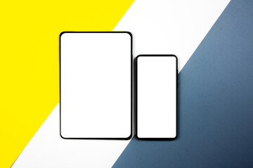 Mock up of a smartphone and a tablet on different colored backgrounds.