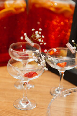 Wineglasses with strawberries, ibright background, red accent.