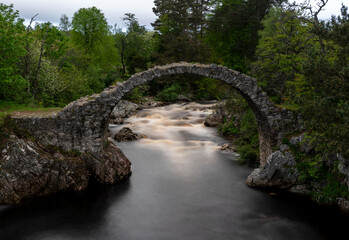 The old packhorse bridge in Carrbridge in the Cairngorms National Park is the oldest stone bridge across the River Dulnain in the Highlands , Scotland