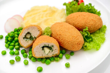 Chicken cutlets in bread crumbs stuffed with butter and herbs