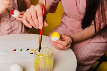 Easter eggs are painted close-up. A believing Christian family getting ready for the holiday.