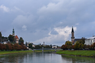 The view from the Makartsteg in Salzburg to the Mullner Church and the Salzburg Christ Church in cloudy weather