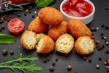 Fried mozzarella, cheddar cheese bites, balls with ketchup