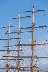 Masts and rigging of a sailing ship against sky