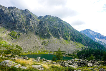 Fototapeta na wymiar View over the Lago di Mognola lake with the beautiful panorama of the Alps