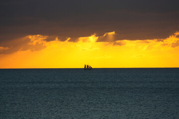 Sunset with a far sailing vessel