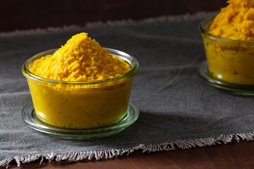 Top view of horseradish and turmeric sauce in bowls with root vegetables ingredients.