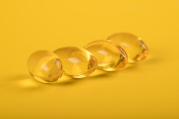 Yellow pills, yellow background. Assorted pharmaceutical medicine pills, tablets and capsules over yellow background. High resolution image for pharmaceutical industry.
