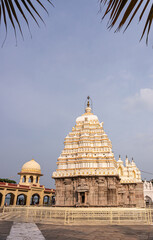 Bagalkot, Karnataka, India - November 8, 2013: Brown stone with white-yellow vimanam of Sri Sangameshwar Temple under blue cloudscape.  