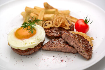Beef rissole, juicy beef steak with egg and potatoes