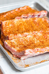 Chef puts spices on the raw piece of meat