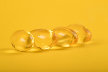 Yellow pills, yellow background. Assorted pharmaceutical medicine pills, tablets and capsules over yellow background. High resolution image for pharmaceutical industry.