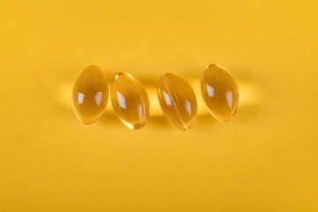 Fototapeta na wymiar Yellow pills, yellow background. Assorted pharmaceutical medicine pills, tablets and capsules over yellow background. High resolution image for pharmaceutical industry.
