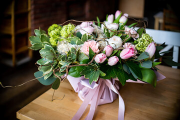 Bouquet of fresh delicate flowers on a dark shady blured background gift