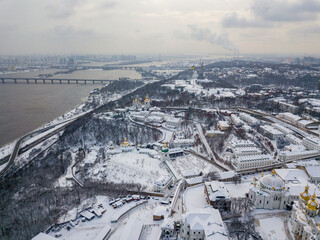 View of the Dnieper and the snow-covered right bank of Kiev. Aerial drone view. Winter snowy morning.