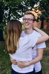 Fototapeta premium Walk of a loving couple through the city and the park. Young people travel to Europe.