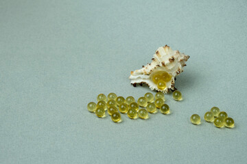 Fish oil capsules in yellow on a white background. Health care, food supplements for beauty. The benefits of Omega 3. 