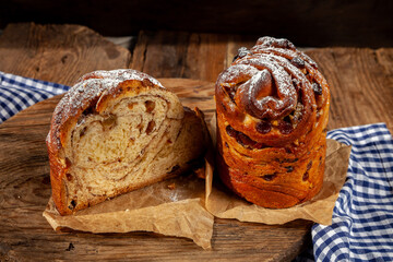 Easter cake kraffin. Kraffins with raisins, candied fruits and poppy seeds, sprinkled with powdered sugar. Close-up of homemade cake. Cruffin. Red colored eggs.