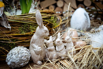 Easter bouquet composition with colorful eggs in nest on wooden background. Angement flower eco with copy space