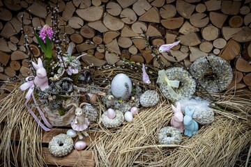 Easter bouquet composition with colorful eggs in nest on wooden background. Angement flower eco with copy space