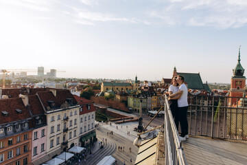 A young couple travels around the European capital. Panorama of the old city.