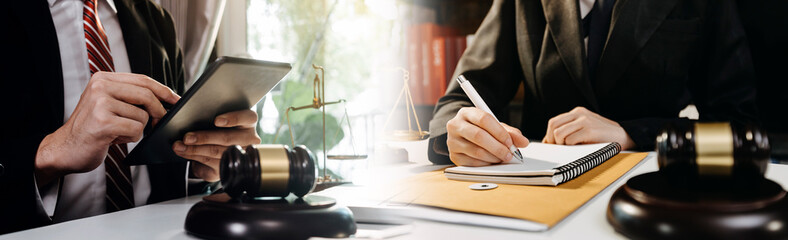 Business and lawyers discussing contract papers with brass scale on desk in office. Law, legal services, advice, justice and law concept picture with film grain effect