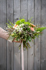 Bouquet of fresh delicate flowers on a dark shady blured background gift