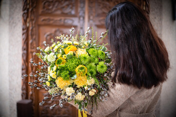 Naklejka premium Bouquet of fresh delicate flowers on a dark shady blured background gift