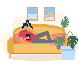 The girl is lying on the couch with a tablet in her hands, work online, training online. Relaxing on the couch