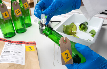Police expert gets blood sample from a green glass bottle in Criminalistic Lab, conceptual image