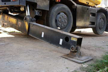 hydraulics crane support. hydraulics crane support is on the ground. Hydraulic foot of the crane.