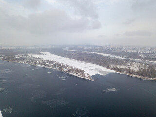 The Dnieper River in Kiev in a blizzard. Aerial drone view. Frosty winter cloudy morning.