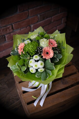 Bouquet of fresh delicate flowers on a dark shady blured background gift