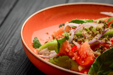 Salad of tomatoes, cucumbers, peppers, onions and greens dressed with olive