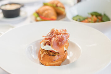 Eggs Benedict on toasted muffins with ham and sauce. Breakfast Buffet Concept, Breakfast Time. Various brunch on the table