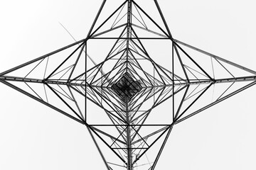 Silhouette of a wind turbine in black and white. Squares and triangles form symmetrical shapes. Cut out design template. Low angle view, concentric.