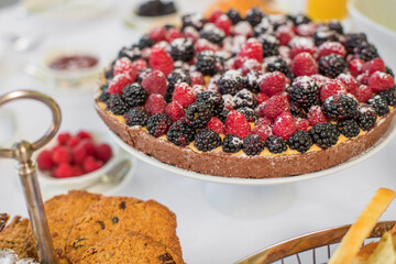 Delicious raspberry  tart (tartlet) with whipped cream. Breakfast Buffet Concept, Breakfast Time. Various brunch on the table