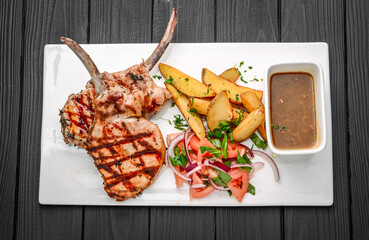 Freshly grilled Tomahawk steaks, with fried potatoes