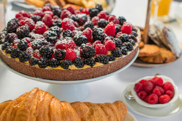 Delicious raspberry  tart (tartlet) with whipped cream. Breakfast Buffet Concept, Breakfast Time. Various brunch on the table