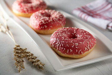 Pink donuts on a white plate