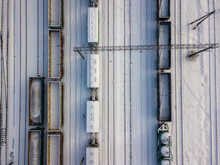 Snow-covered freight trains on rails in Kiev. Aerial drone view. Winter snowy morning.