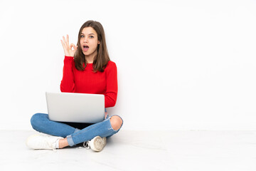 Tenaager girl working with pc isolated on white background surprised and showing ok sign